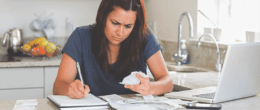 A woman calculating her taxes.