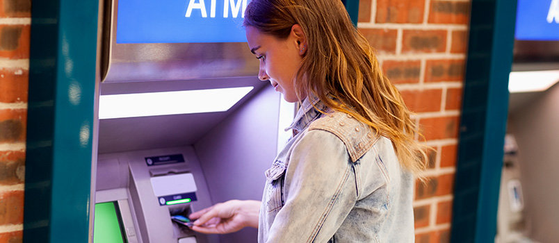 A girl withdrawing money from ATM.