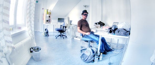 man with sunglasses sitting comfortly in freindly workspace