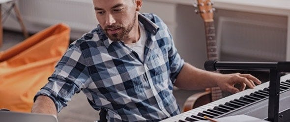 A male musician playing a piano