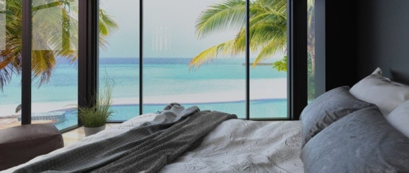 A bedroom with a picturesque beach view