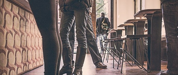 Legs of people standing in a restaurant