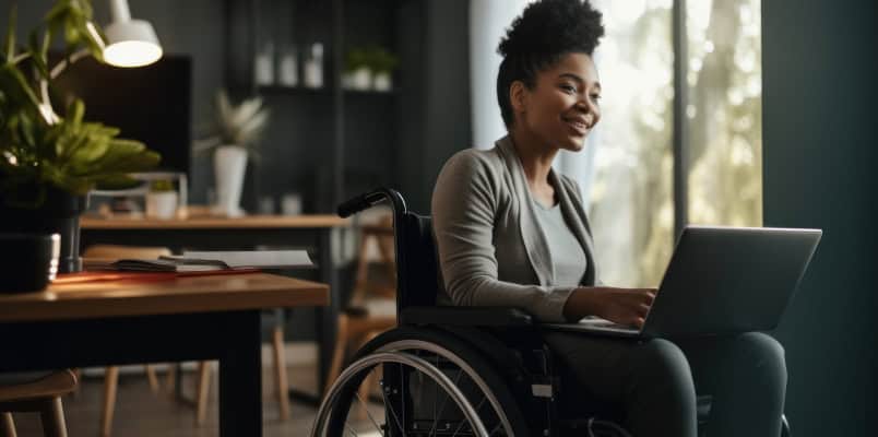 A woman in a wheelchair uses a laptop to learn more about Form 1099-QA