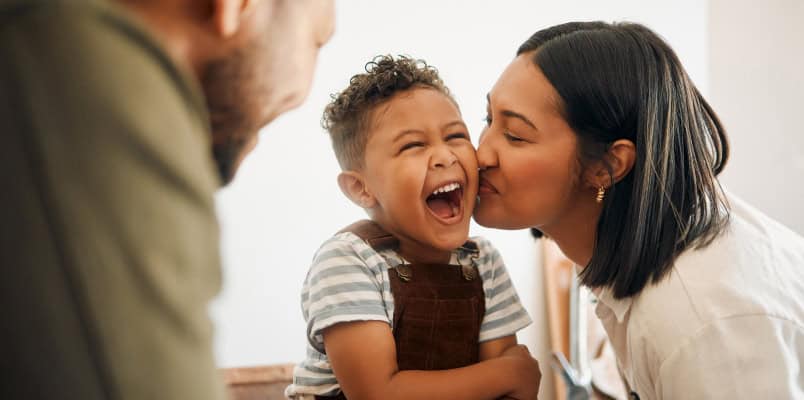 Two young parents and their smiling small child