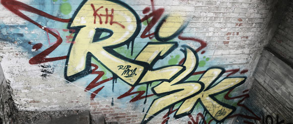 A graffiti painting on an old brick wall