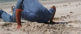 a man sticking his head in the sand
