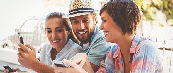 Three millennials enjoying with mobiles