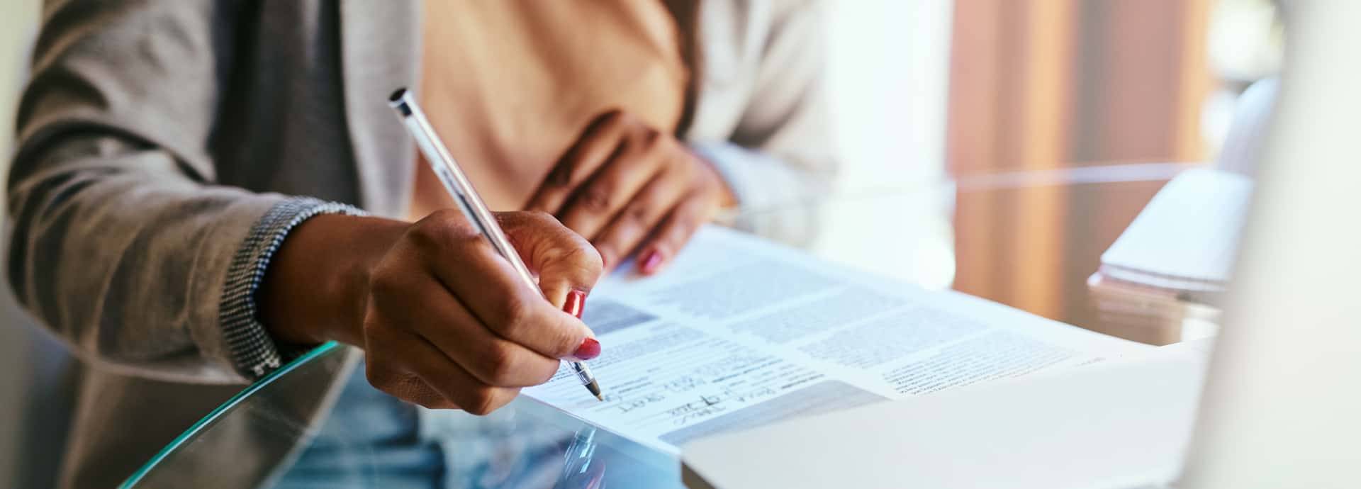 A lady signing on a document