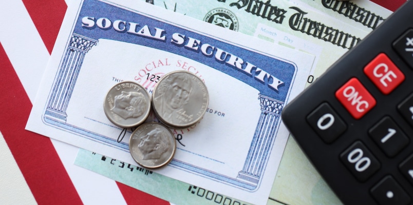 Social Security card, coins, and calculator symbolizing SSN vs. ITIN comparison and taxpayer identification number differences.