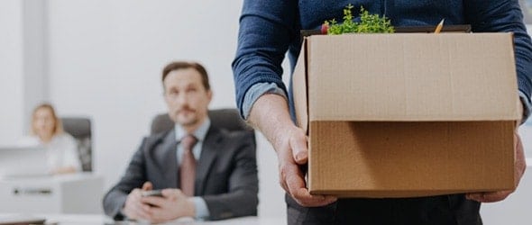 Quitting-Your-Corporate-Job-Blog Man holding a box with his possessions as he quits his corporate job to freelance.