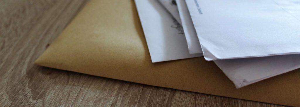 Set of stimulus payment papers lying on a wooden table