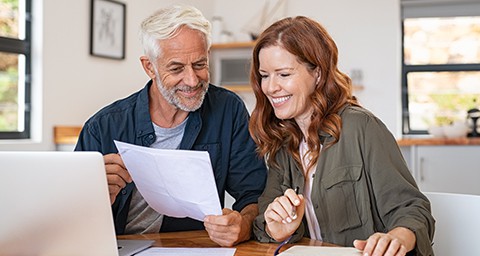Older couple looks over their retirement accounts and discusses the COVID relief options.