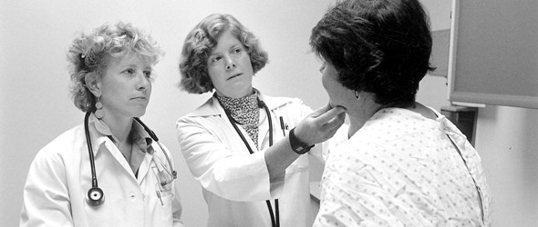 Two professional doctors examining patient