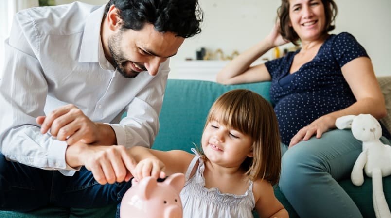 Father & mother with their child saving for their retirement with minimal income