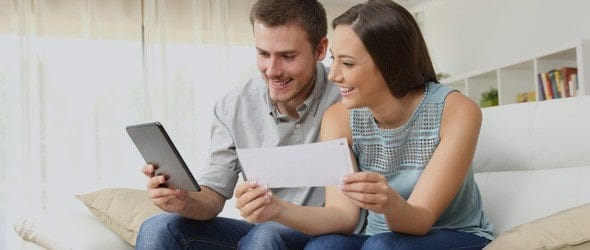 A couple checking their loan on form and tablet