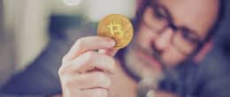 A man holding a bitcoin