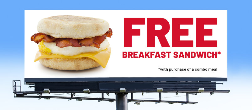 A horizontal billboard for burger advertising with the text "FREE Breakfast Sandwich"