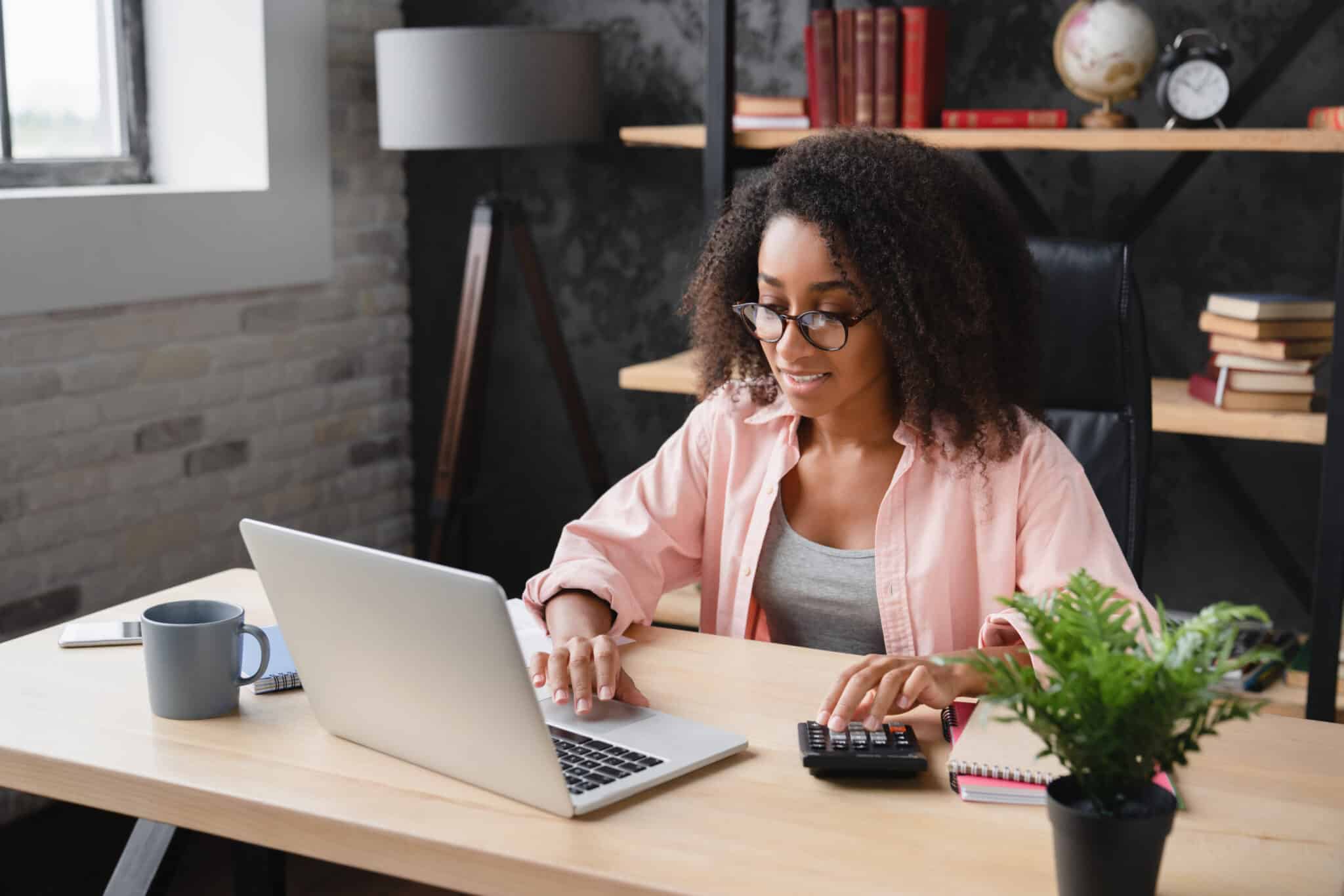 Person filing taxes online with a calculator