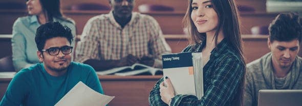 refinancing-student-loans-Credible Student in a college classroom thinking about refinancing her student loans.