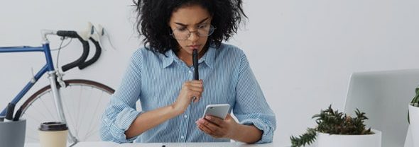 the-difference-between-tax-deductions-credits-Blog Young woman reviews the difference beween tax deductions and credits.