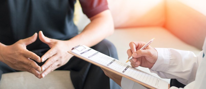 A man consulting with a doctor.