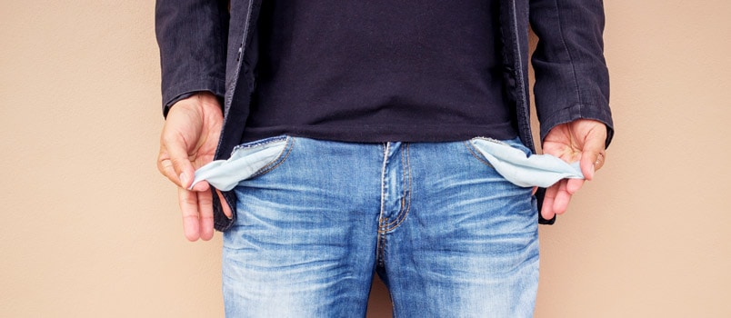 Man showing empty pockets of his jeans